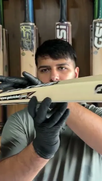 A Panther bat held up in front of the bat racks